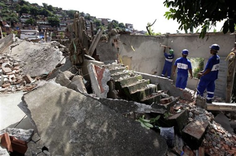 Workers demolish a home at the Morro do Urubu slum in Rio de Janeiro, Brazil, on Monday.